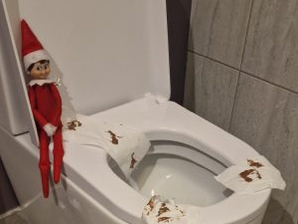 Elf surrounded by scattered toilet paper, cotton balls, and washcloths.
