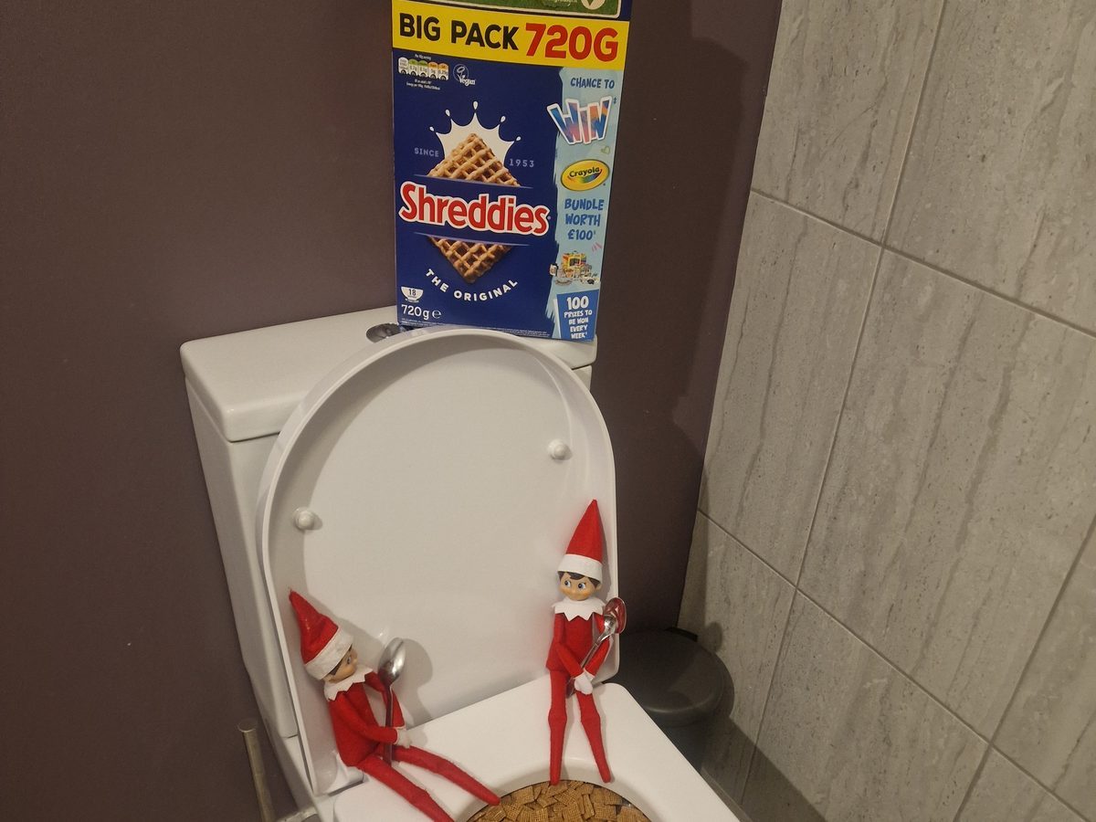 Toilet bowl filled with cereal creating humorous bathroom prank scene.
