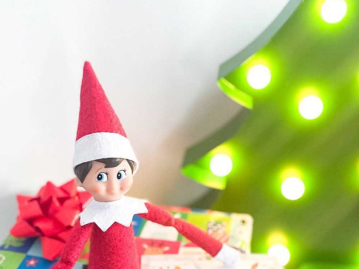 Elf head poking out of wrapped gift box with personalized I'm Back arrival letter.