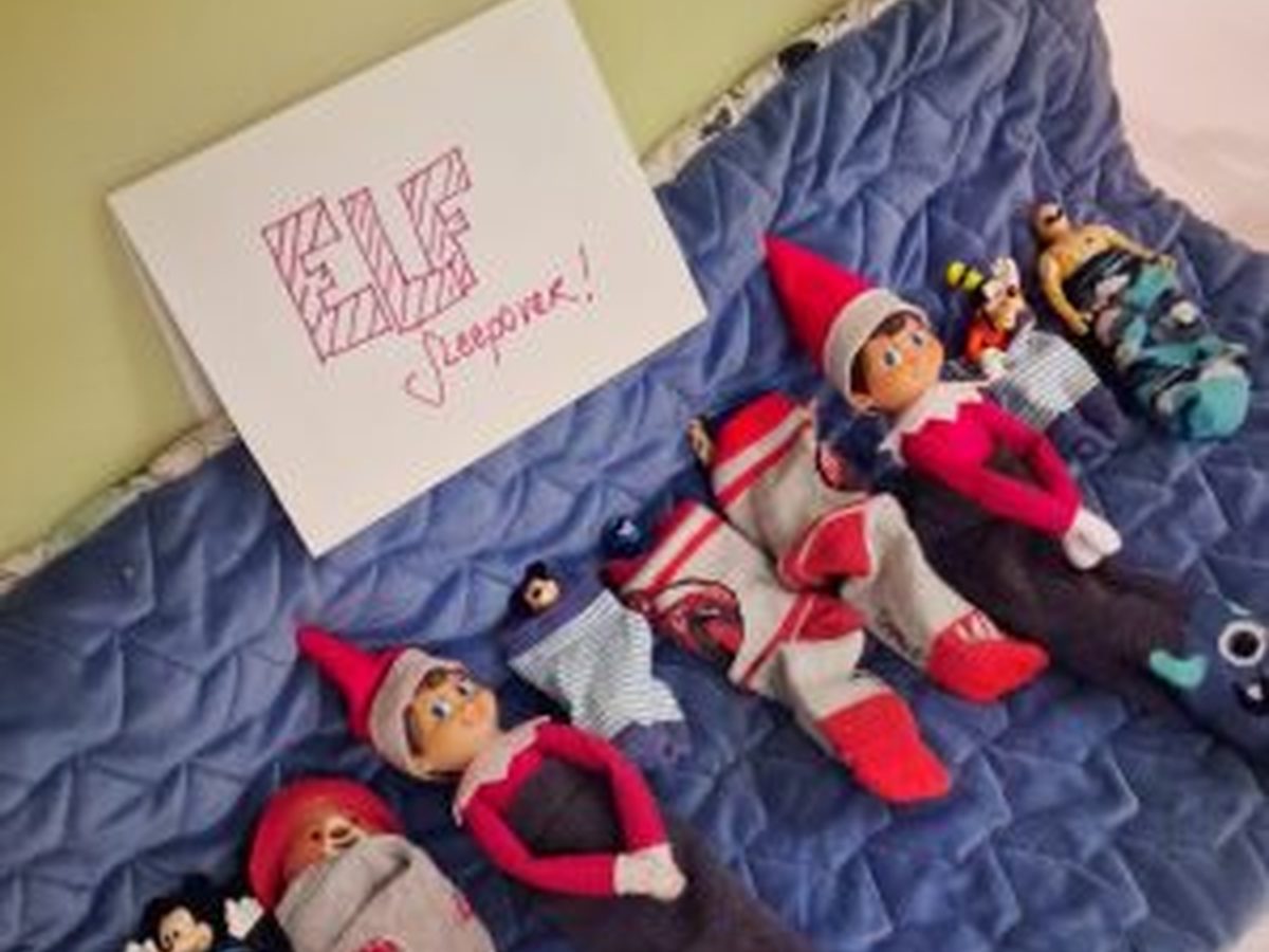 Elf and toys nestled together in clean socks as sleeping bags.