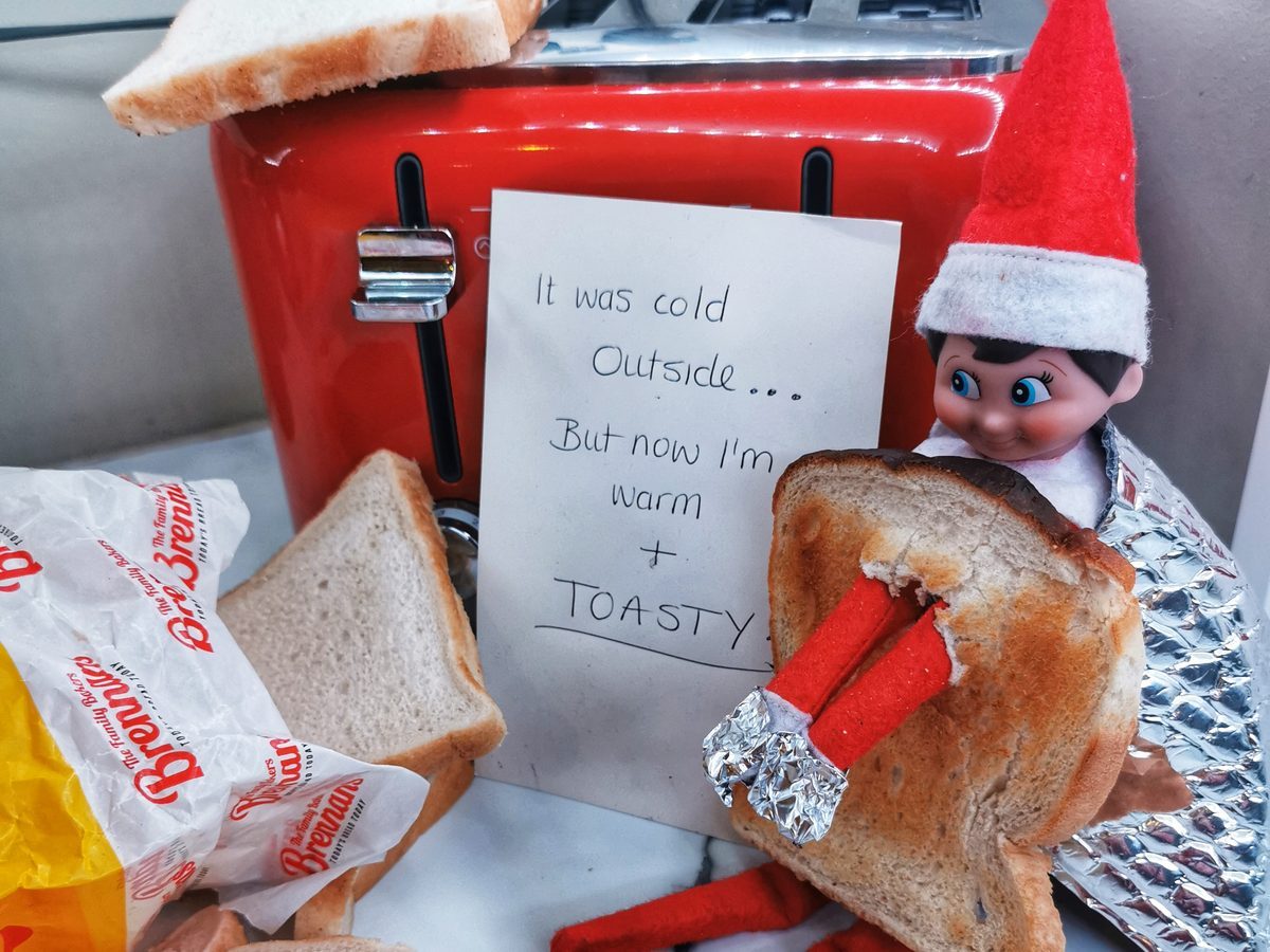 Elf tucked inside sliced bread like a sleeping bag.
