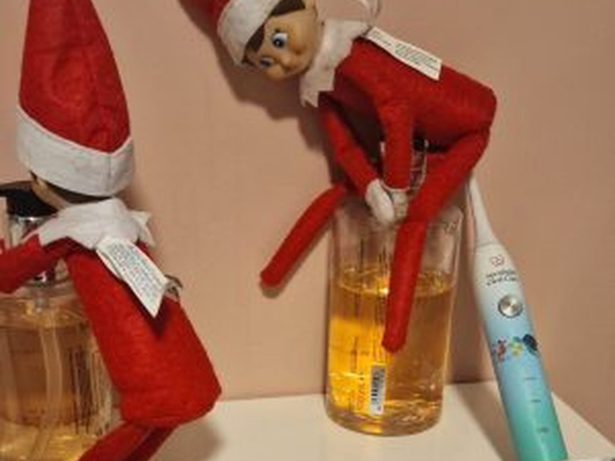 Elf using family toothbrushes to clean bathroom sink and surfaces.