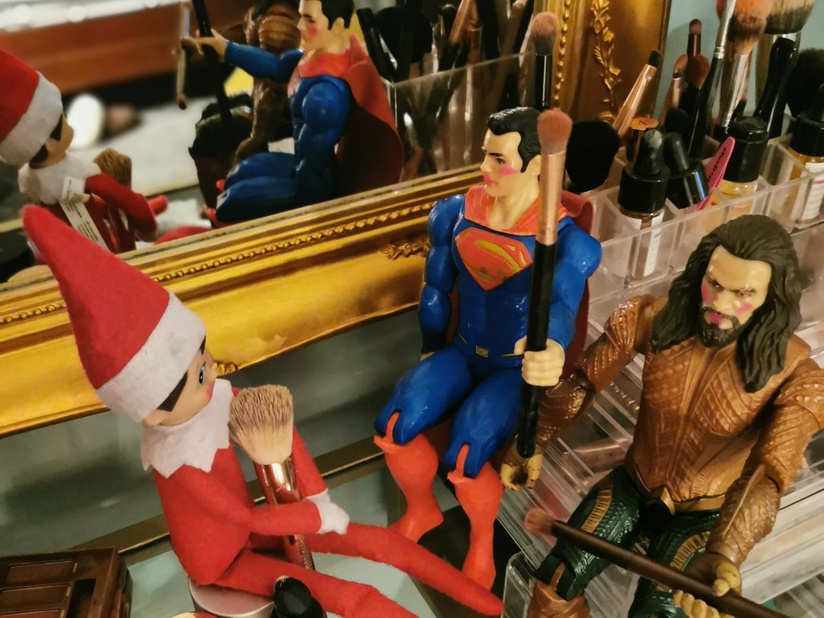 Elf styling toys with festive accessories and holiday decorations applied.